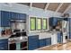 Farmhouse sink in a spacious kitchen, featuring granite countertops and stainless steel appliances at 1355 Bowling Road, Fuquay Varina, NC 27526