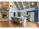 Well-appointed kitchen featuring an island, stainless steel appliances, and brick fireplace at 1355 Bowling Road, Fuquay Varina, NC 27526