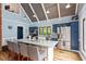 Bright kitchen with hardwood floors, granite countertops, stainless steel appliances, and barstool seating at 1355 Bowling Road, Fuquay Varina, NC 27526