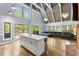 Open-concept living area with an island, fireplace, and access to the outdoor deck at 1355 Bowling Road, Fuquay Varina, NC 27526