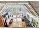 Open-concept living space with a large gray sectional, natural light, and hardwood floors at 1355 Bowling Road, Fuquay Varina, NC 27526