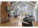 Open concept living room featuring hardwood floors, fireplace, a cathedral ceiling, and an island with bar seating at 1355 Bowling Road, Fuquay Varina, NC 27526