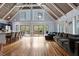 Open-concept living room showcasing hardwood floors, high ceilings, a fireplace, and access to the deck at 1355 Bowling Road, Fuquay Varina, NC 27526
