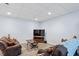 Cozy living room with two comfortable recliners, recessed lighting, and wood-look flooring at 1355 Bowling Road, Fuquay Varina, NC 27526