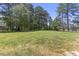 Expansive lawn area with mature trees, perfect for recreation or gardening at 1355 Bowling Road, Fuquay Varina, NC 27526