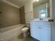 Well-lit bathroom with a white vanity, toilet, and a shower-tub combo with tile surround at 159 Yellow River Way, Garner, NC 27529