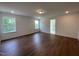 Bright bedroom with multiple windows, hardwood floors, and an en suite bathroom entrance at 159 Yellow River Way, Garner, NC 27529
