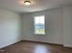 Neutral-toned bedroom features a large window and hardwood floors at 159 Yellow River Way, Garner, NC 27529