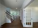 Inviting foyer with hardwood floors, a staircase, and a view into the open-concept living space at 159 Yellow River Way, Garner, NC 27529