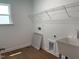 The spacious laundry room is equipped with a utility sink, window and overhead shelving at 159 Yellow River Way, Garner, NC 27529
