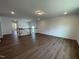 Spacious living room featuring hard wood floors, recessed lighting, and open concept layout to the foyer at 159 Yellow River Way, Garner, NC 27529