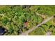 Wooded lot with a house featuring a red roof, captured from an aerial perspective at 1622 N Carolina 98 Hwy W, Louisburg, NC 27549