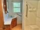 Bathroom with a shower/tub combo, vanity, and wood framed window at 1622 N Carolina 98 Hwy W, Louisburg, NC 27549