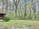 Exterior view of the brick home, green lawn, and surrounding trees at 1622 N Carolina 98 Hwy W, Louisburg, NC 27549