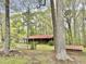 View of a charming brick home with a covered porch and red metal roof at 1622 N Carolina 98 Hwy W, Louisburg, NC 27549