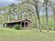 Exterior of the brick home, showcasing a generous lot and covered porch at 1622 N Carolina 98 Hwy W, Louisburg, NC 27549