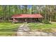 View of charming brick home featuring a covered porch and well maintained lawn at 1622 N Carolina 98 Hwy W, Louisburg, NC 27549