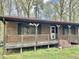Charming single story brick home featuring a covered porch with wooden railings at 1622 N Carolina 98 Hwy W, Louisburg, NC 27549