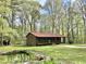 Charming brick home with a covered porch, red metal roof and a lovely pond at 1622 N Carolina 98 Hwy W, Louisburg, NC 27549