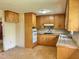 View of the kitchen featuring wood cabinets and an adjacent room with an exterior door at 1622 N Carolina 98 Hwy W, Louisburg, NC 27549