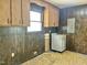 Laundry room with wood paneled walls and cabinets, including a washing machine at 1622 N Carolina 98 Hwy W, Louisburg, NC 27549