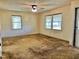 Living room with two windows, ceiling fan, and neutral walls at 1622 N Carolina 98 Hwy W, Louisburg, NC 27549