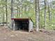 A rustic outbuilding provides extra storage or workspace in a secluded setting at 1622 N Carolina 98 Hwy W, Louisburg, NC 27549