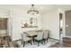 Modern dining area featuring an elegant chandelier and stylish decor elements at 1809 Angelonia Way, Fuquay Varina, NC 27526