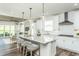 Bright kitchen boasts a large center island with barstool seating and modern appliances at 1809 Angelonia Way, Fuquay Varina, NC 27526