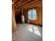 Unfinished attic space with exposed wood and a window providing natural light at 20 Willows Den Ct, Youngsville, NC 27596