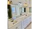 Bright bathroom featuring dual sinks, a large mirror, and a separate tub and shower area at 20 Willows Den Ct, Youngsville, NC 27596