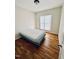 Cozy bedroom with a bed and hardwood floors, illuminated by natural light from the window at 20 Willows Den Ct, Youngsville, NC 27596