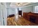 Spacious bedroom with tray ceilings, hardwood floors, and natural light from large windows at 20 Willows Den Ct, Youngsville, NC 27596