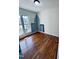 Bright bedroom featuring hardwood floors and an artistic painted cityscape on the wall at 20 Willows Den Ct, Youngsville, NC 27596