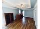 Large bedroom with tray ceilings, hardwood floors, and natural light from large windows at 20 Willows Den Ct, Youngsville, NC 27596