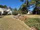 Well-maintained front yard with a rock garden and mature landscaping providing year round interest at 20 Willows Den Ct, Youngsville, NC 27596