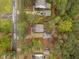 Aerial view of a property showcasing a well-maintained roof, landscaped yard, and a private driveway surrounded by trees at 2007 Watson Rd, Durham, NC 27704