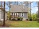 Charming home featuring a cozy backyard with a wooden deck, lush lawn, and privacy fence at 2007 Watson Rd, Durham, NC 27704