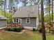 Backyard featuring a wooden deck, grey siding, and a well maintained lawn at 2007 Watson Rd, Durham, NC 27704