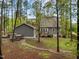 The well-manicured lawn with a deck and detached garage with the main house in the background at 2007 Watson Rd, Durham, NC 27704