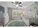 Charming Bedroom features whimsical wallpaper, a white crib, coordinating dresser, and soft rug, perfect for a baby's room at 2007 Watson Rd, Durham, NC 27704