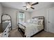 Cozy bedroom with soft natural light, a comfortable iron frame bed, and stylish decor, creating a restful retreat at 2007 Watson Rd, Durham, NC 27704