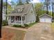 Two-story home features a welcoming front porch and a detached two-car garage at 2007 Watson Rd, Durham, NC 27704