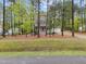 Two-story home surrounded by trees, featuring a welcoming front porch at 2007 Watson Rd, Durham, NC 27704