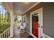 Inviting front porch features rocking chairs, stylish lighting, and a red front door at 2007 Watson Rd, Durham, NC 27704