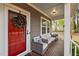 Welcoming front porch with comfortable seating and a red front door at 2007 Watson Rd, Durham, NC 27704