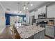 Modern kitchen featuring a large island with seating, stainless steel appliances at 2007 Watson Rd, Durham, NC 27704