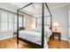 Bedroom featuring four-poster bed frame, ceiling fan, and hardwood flooring at 214 Lions Gate Dr, Cary, NC 27518