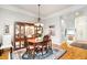 Formal dining room featuring hardwood floors, a chandelier, and a built-in china cabinet at 214 Lions Gate Dr, Cary, NC 27518