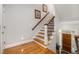Welcoming foyer with hardwood floors and staircase, bathed in natural light from the front door windows at 214 Lions Gate Dr, Cary, NC 27518